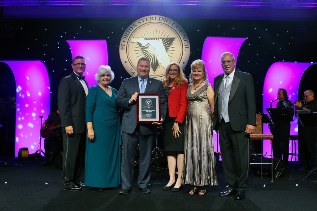 Michael Myhre, CEO and Network State Director for the Florida SBDC Network, and Dr. Cheryl Kirby, Chief Strategy and Branding Officer for the Florida SBDC, accept the best practice award at the 24th Annual Florida Sterling Conference