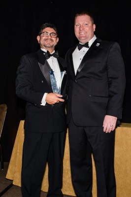 Javier Marin (left) accepts the Florida SBDC Network Florida Star of the Year award from Michael Myhre (right)