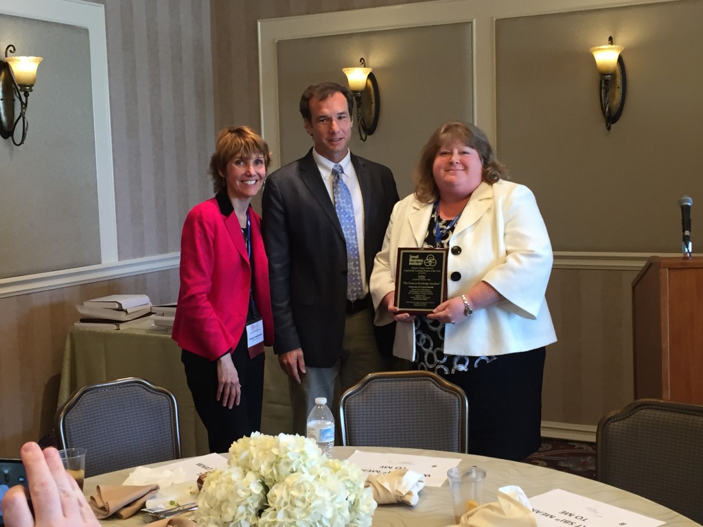 Jill Kaufman (right), Florida SBDC at UCF Assistant Director and SBI Program Manager, accepts one of UCF's awards from Denise Cumberland, SBI VP of Research and Publications, and John Batchelor, SBI President